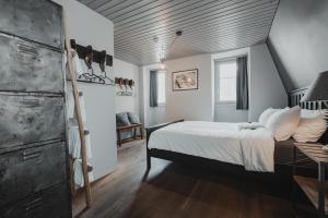 a bedroom with a bed and a wooden ceiling at No8 Boutique Hotel - self check in in Unterseen