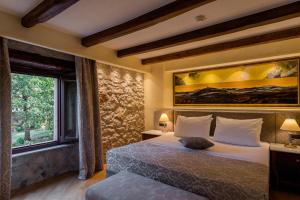 a bedroom with a bed and a large window at Heritage Hotel San Rocco in Brtonigla