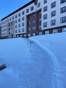 a pile of snow in front of a building at Milmari Spa & Wellness, N22 Apartman sa pogledom in Kopaonik