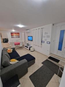 a living room with a couch and a tv at Beautiful house Lanna in Izola