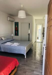 a bedroom with a bed and a red blanket at Case vacanze I trabocchi in San Vito Chietino