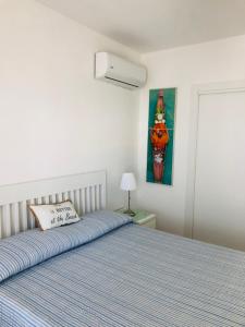 a bedroom with a bed and a painting on the wall at Case vacanze I trabocchi in San Vito Chietino