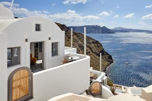 a view of the ocean from a house at Allure Breeze Suites in Oia