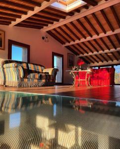 a living room with a couch and a swimming pool at Agriturismo La Corte del Sole in Siena +86 photos