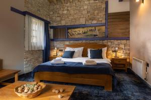 a bedroom with a bed and a brick wall at Herceg Etno Selo Međugorje in Međugorje