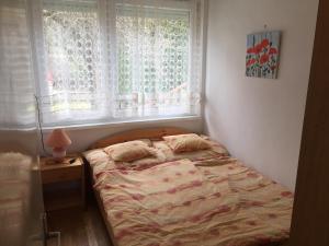 Postel nebo postele na pokoji v ubytování Sirály Apartman