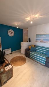 a bedroom with a bed and a clock on the wall at appartement T2 biscarosse plage in Biscarrosse-Plage