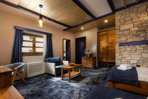a hotel room with a bed and a living room at Herceg Etno Selo Međugorje in Međugorje