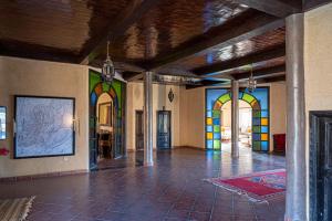 an empty room with colorful walls and floors and a room with a unintention at Auberge Kasbah Chez Amaliya in Tafraoute