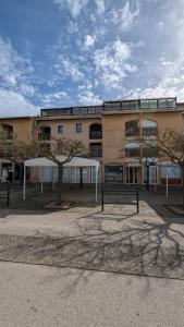 a large building with trees in front of it at appartement T2 biscarosse plage in Biscarrosse-Plage