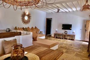 a living room with a couch and a tv at Antares Villa in Kiwengwa