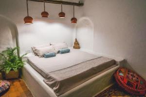 Postel nebo postele na pokoji v ubytování Boho's Hotel