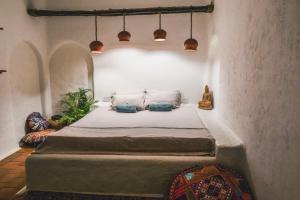 Postel nebo postele na pokoji v ubytování Boho's Hotel