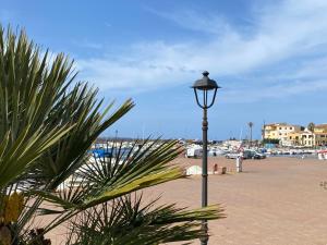 a street light next to a beach with a parking lot at Concas Apartaments in Portoscuso +20 photos