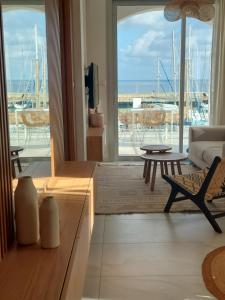 a living room with a view of the ocean at Latchi Marina View in Polis Chrysochous
