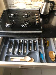 a stove top oven with utensils on a counter at MEK HOMEs 2 in Fethiye