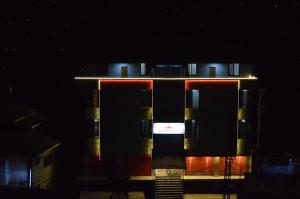 a tall building at night with its lights on at Hotel Crown City in Muzaffarabad