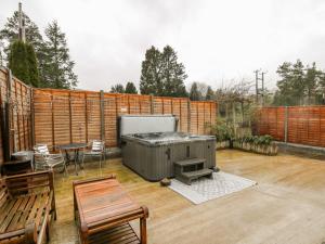 a patio with a grill and a table and chairs at The Searle in Llandrindod Wells