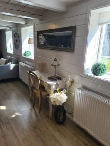 a living room with a table and a couch at Tosthult Holiday 2 in Lönsboda
