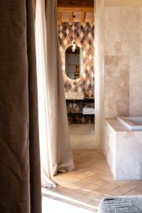 a view of a bathroom with a mirror and curtains at Mormoraia in San Gimignano