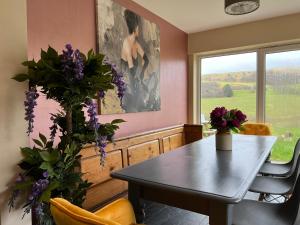 a dining room with a table and a window at Healing Pastures Farm in Llanbrynmair