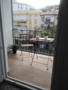 a view of a balcony with a table and bench at Sevilla Macarena apartamento 3 dormitorios in Seville