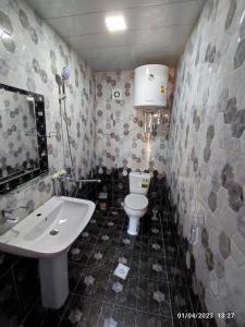 a bathroom with a sink and a toilet at Sezam in Bukhara