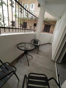 a balcony with a table and chairs and a staircase at Apartment Maska in Budva