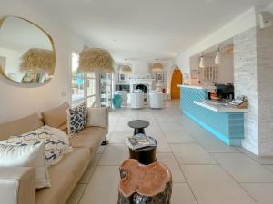 a living room with a couch and a counter at Le Mouillage in Saint-Tropez