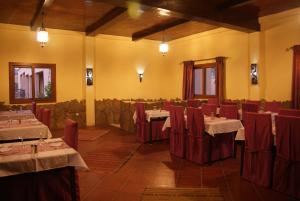a restaurant with tables and chairs in a room at Auberge Kasbah Chez Amaliya in Tafraoute