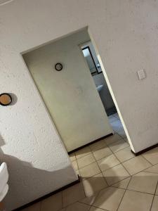 een hal met een deur naar een badkamer met een toilet bij Via Vercelli in Sandton
