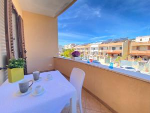 a table and chairs on a balcony with a view at Maison Soleil Guest House Gallipoli in Gallipoli