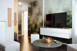 a living room with a tv on a wall at Elegant 1-bedroom apartment near hill forest in Ljubljana