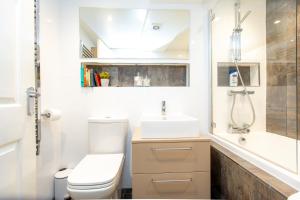 a bathroom with a toilet and a sink and a shower at The Ilkley Hideaway in Ilkley