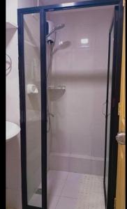 a shower with a glass door in a bathroom at One spatial iloilo city two bedroom condo with free Netflix wifi pool and Gym in Iloilo City