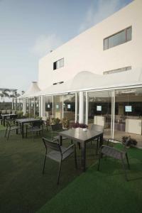 a group of tables and chairs in front of a building at Hotel Pal Heights in Bhubaneshwar