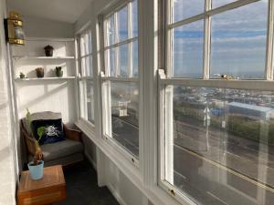 a room with large windows with a view of a city at Paragon Home in Ramsgate