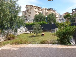 a grassy area in a city with a building at B&B Villa Chiara Bed and Breakfast in Taormina