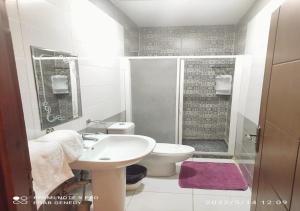 a bathroom with a sink and a toilet and a shower at columbia sky city hotel in Cairo +126 photos