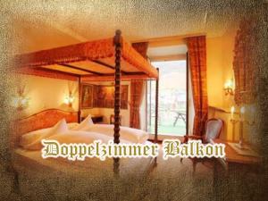 a picture of a bedroom with a bed with a canopy at Burg-Hotel & Hostel Cochem in Cochem