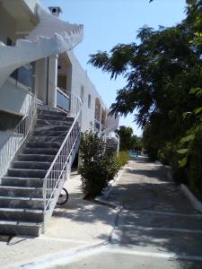 a building with stairs on the side of a street at GOLDEN BEACH in Souvala