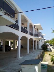 a large white building with a parking lot at GOLDEN BEACH in Souvala