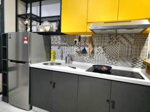 a kitchen with a stainless steel refrigerator and a sink at Liberty Arc Studio 舒适和家温暖的感觉 in Ampang