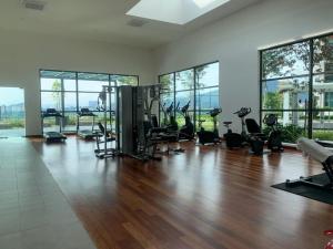 a gym with a hardwood floor and large windows at Liberty Arc Studio 舒适和家温暖的感觉 in Ampang