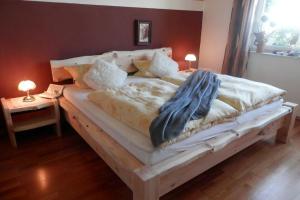 a bedroom with a large bed with a wooden frame at Ferienwohnungen Christa Grabmeier in Grainet