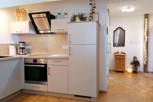 a kitchen with a white refrigerator in a room at Ferienwohnungen Christa Grabmeier in Grainet