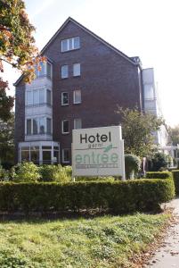 a hotel with an office sign in front of a building at Entrée Groß Borstel Garni Hotel in Hamburg