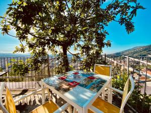 a table and chairs on a balcony with a tree at 88 Miglia in La Spezia