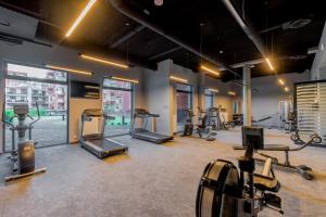 a gym with treadmills and elliptical machines at Pool & Leisure Apartament Polanki Park in Kołobrzeg