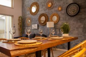 uma sala de jantar com uma mesa com óculos e espelhos em Ocean House em Ovar